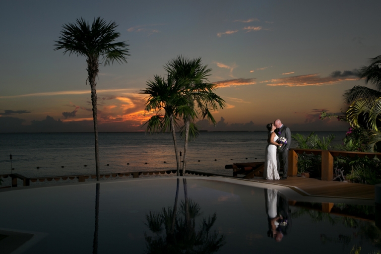 Bride and groom at sunset at Zoetry Isla Mujeres.
