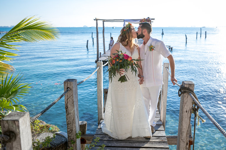 Bride groom kissing on pier