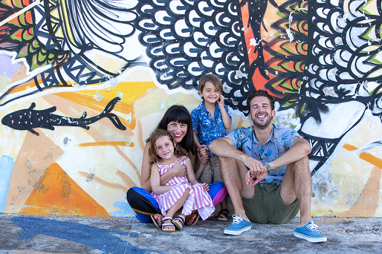 Family in front of colorful mural